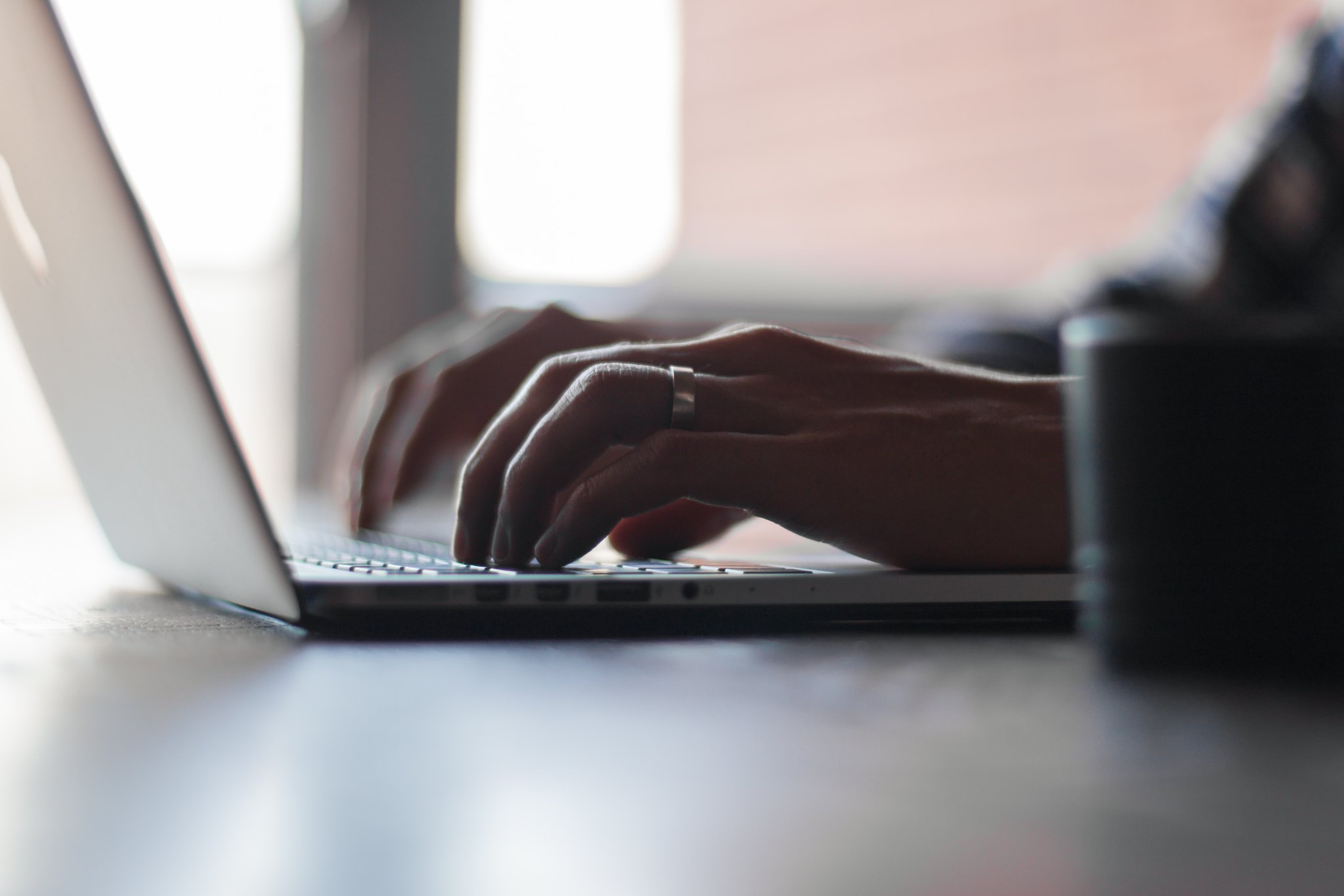 Shows a job searcher, like those helped by a recruitment agency, researching positions
